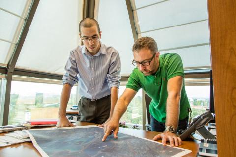 two employees looking at a map