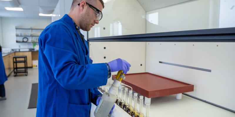 lab technician prepares uranium sample at src lab under fumehood
