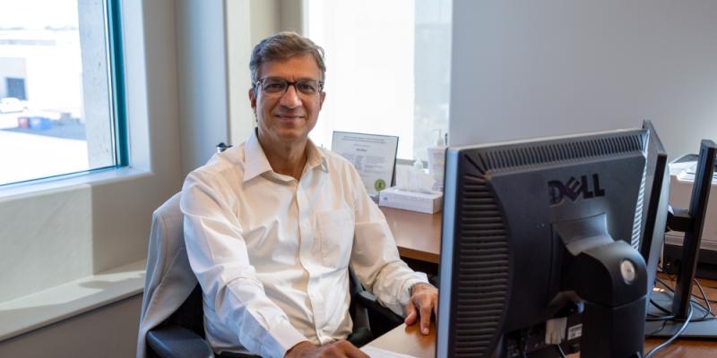 sunil sohani from src safety services sits at desk in office 