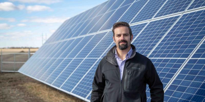 SRC engineer in front of solar panel array