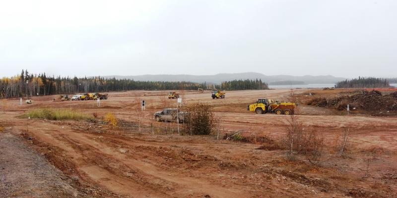 large trucks driving on dirt