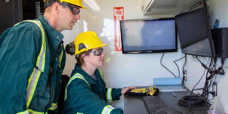 two src technicians conduct air sampling tests