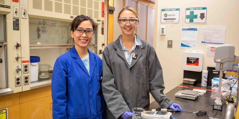two src female lab employees at the bench
