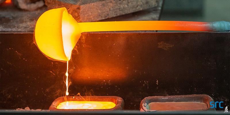 ladle pouring melted metal into a square case at src's rare earth processing facility
