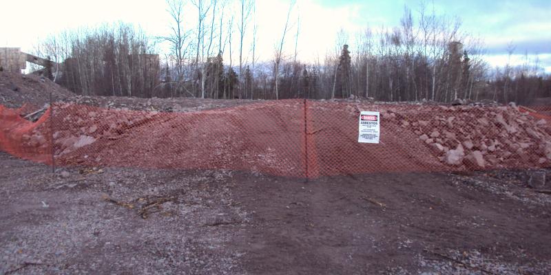 dirt pile with orange safety fence
