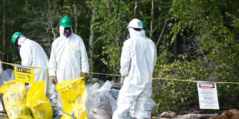 trained demolition workers remove asbestos