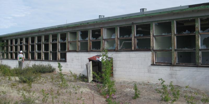 low concrete building with broken windows