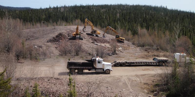 Excavators were used to bury steel and concrete in waste rock adjacent to the Cenex uranium mine, near Uranium City, Sask.