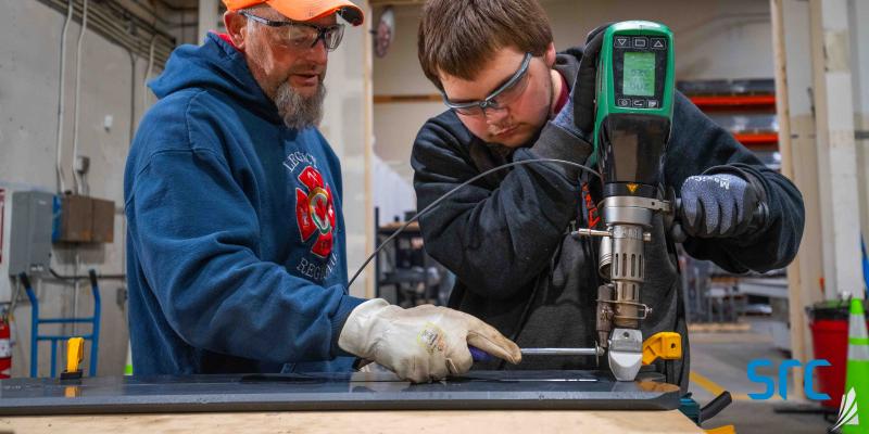 instructor and student welding at src's fabrication facility