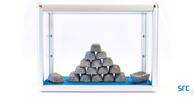 stack of metal bars called ingots in a case at src's rare earth processing facility