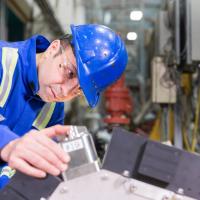 engineer inspects gamma ray tomography unit