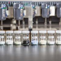 src lab with rare earth minerals on bench top and equipment in background