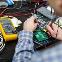 lab technician works on circuit board