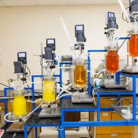rare earths lab with orange glass containers