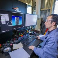 src research engineer examining results of industrial ct scanner