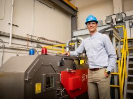 SRC employee stands beside xrt sorter